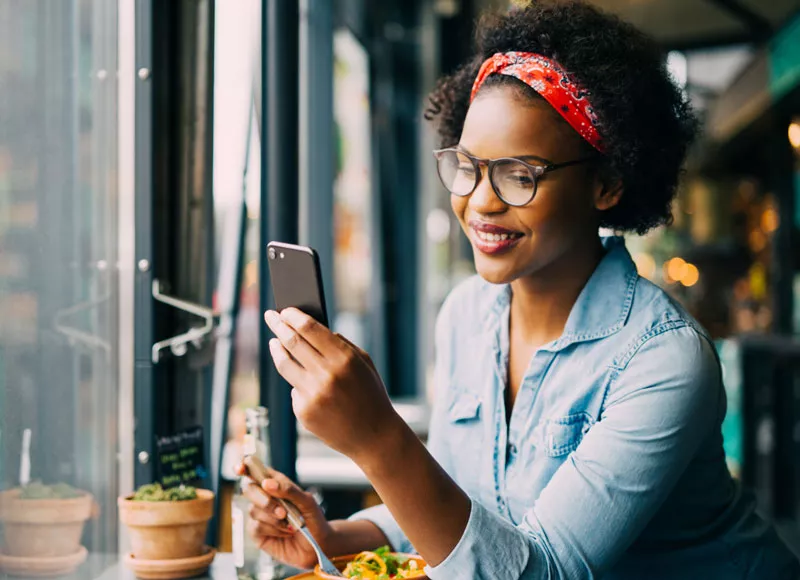 happy woman looking at her phone