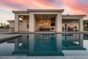 exterior view of home and pool at sunset