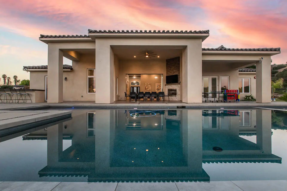 Feature-Image exterior view of home and pool at sunset