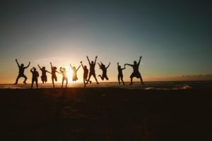 silhouette of people jumping in the air